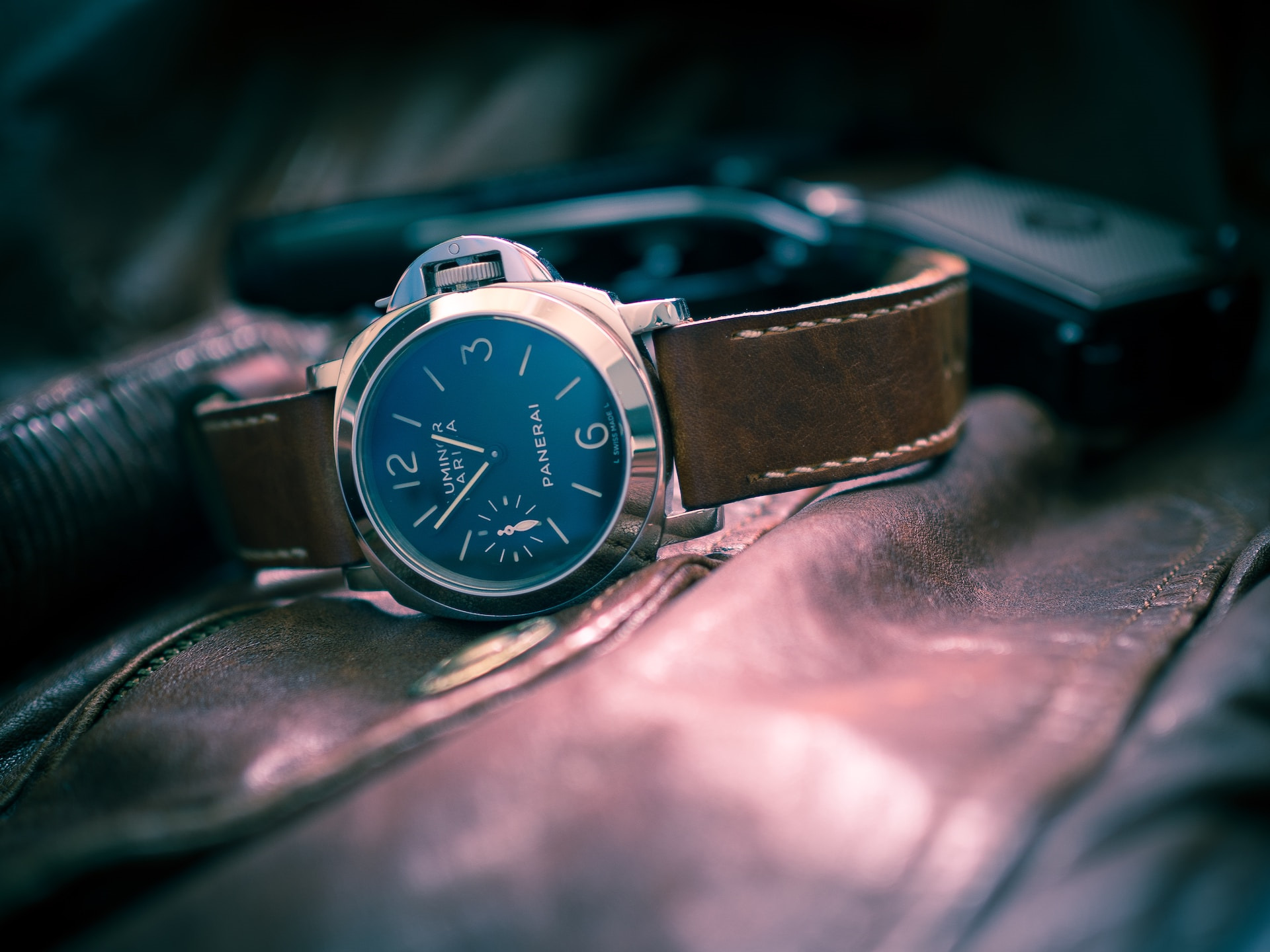 a Panerai watch resting on a leather surface